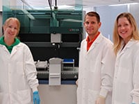 Forensic scientists Jennifer Jarrett, Robert Binz and Heather Pevney (left to right) with one of the DNA Section’s Freedom EVO workstations